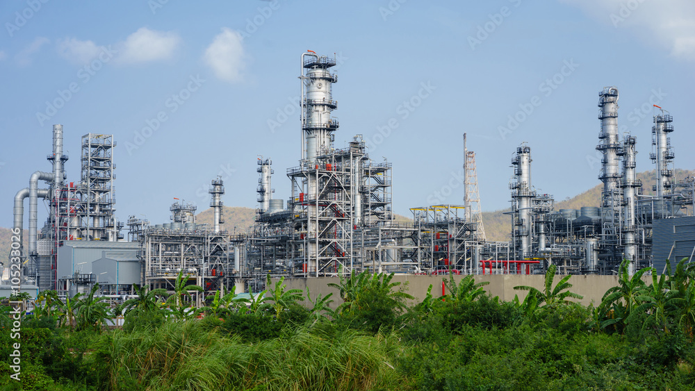 green grass field and Oil refinery factory plant or petrochamica