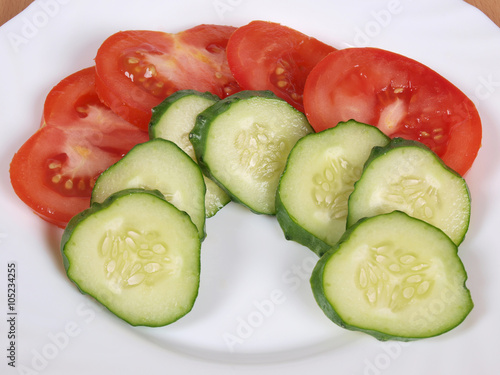 Tomato and cucumber on white plate