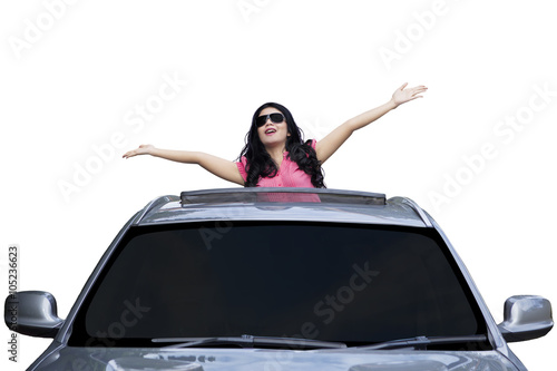 Woman standing on the sunroof of car photo