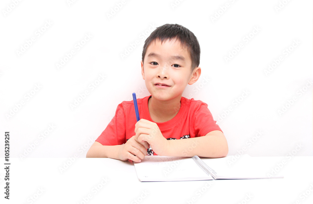 Inspired little boy at the table draw with crayons, isolated on Inspired little boy at the table draw with crayons, isolated on