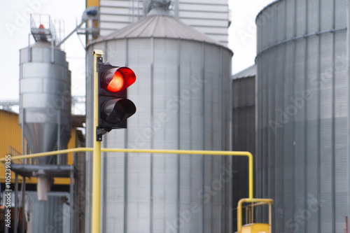 traffic lights and agricultural grain elevator building for grain storage and railroad © mikola249