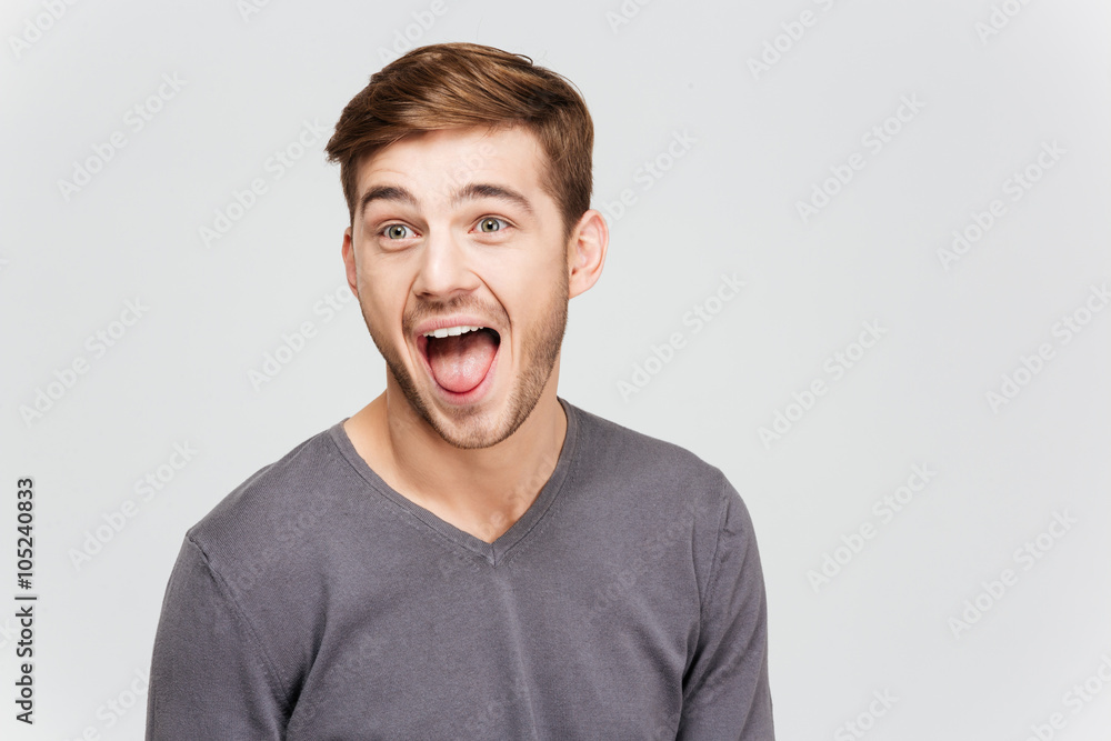 Funny amusing young man in grey pullover screaming Funny amusing young man in grey pullover screaming