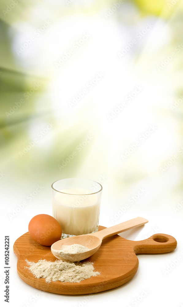 milk, egg, flour, spoon and board on sun background milk, egg, flour, spoon and board on sun background