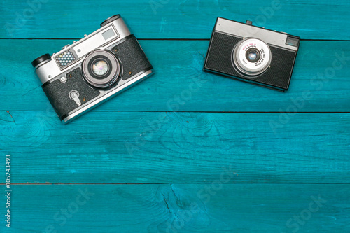 Two retro camera lying on the aged boards photo