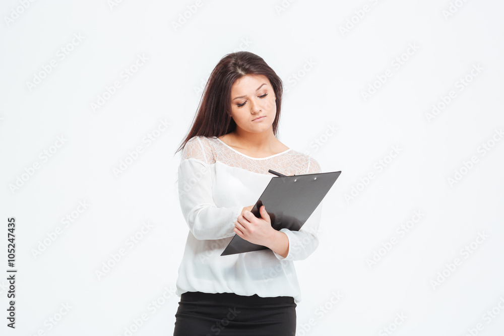 Businesswoman making notes in clipboard Businesswoman making notes in clipboard