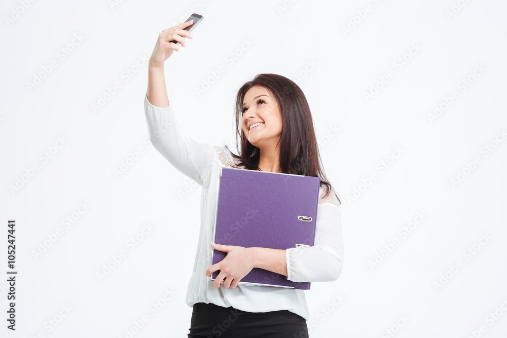 Smiling businesswoman making selfie photo on smartphone Smiling businesswoman making selfie photo on smartphone