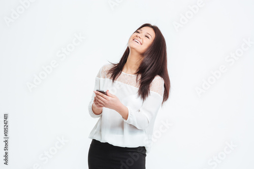 Laughing businesswoman using smartphone
