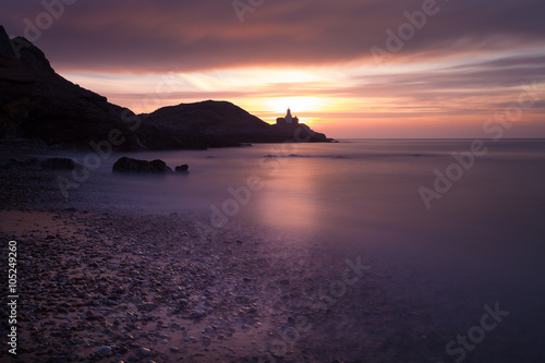 Sunrise at Bracelet Bay  featuring Mumbles Lighthouse in Swansea  South Wales