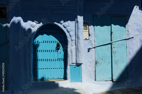 shadows and blue doors in the blue town of Chefchaouen photo