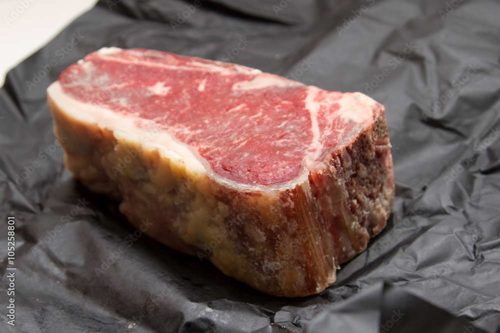 Raw dry aged t-bone steak Raw dry aged t-bone steak