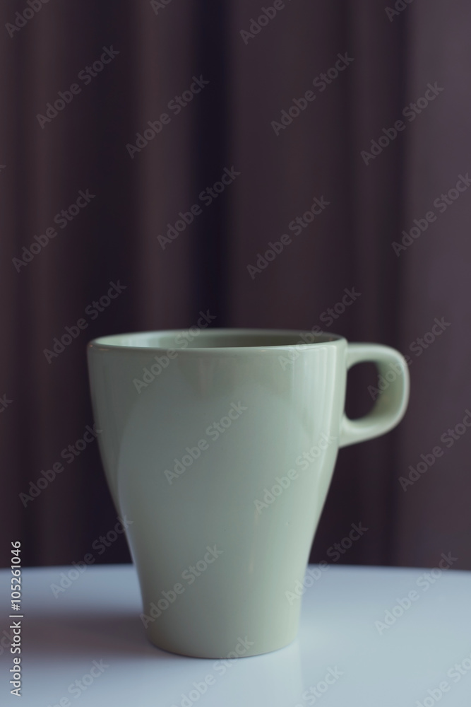 Obraz premium green teacup near window