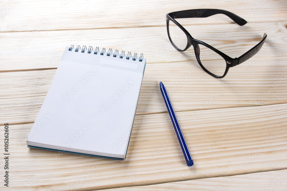 Back to school. Blank note pad, notebook with pen and glasses Back to school. Blank note pad, notebook with pen and glasses