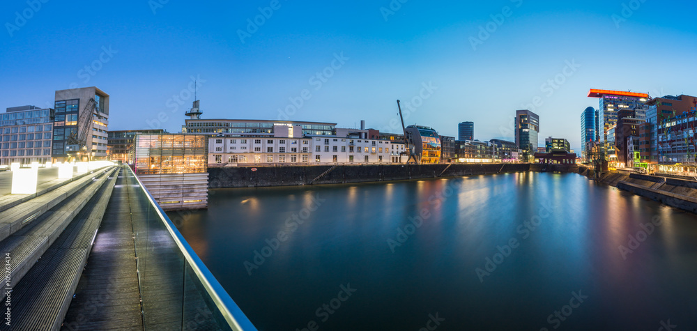 Panorama view of the Media harbor in Dusseldorf in the early evening, Germany. Nice reflection in the harbor basin.
