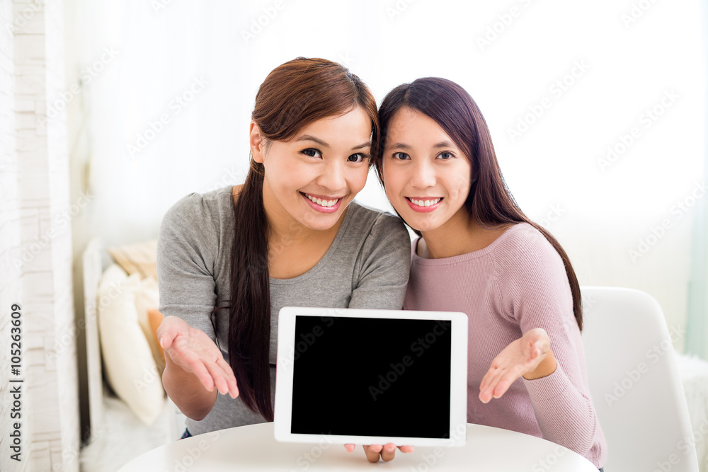 Girls friend showing the blank screen of digital tablet Girls friend showing the blank screen of digital tablet