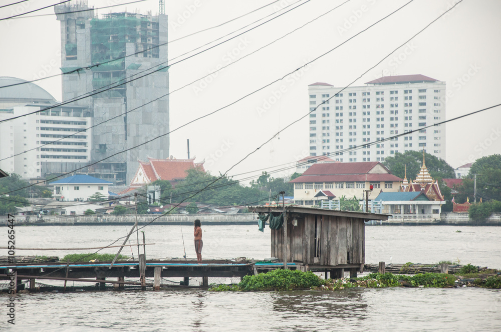 Poor hut on riverside, taken from Bangkok Thailand Poor hut on riverside, taken from Bangkok Thailand