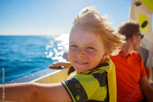 little kid boy enjoying sailing boat trip