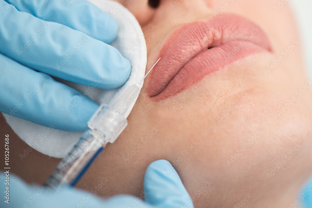 woman gets injection in her lips woman gets injection in her lips