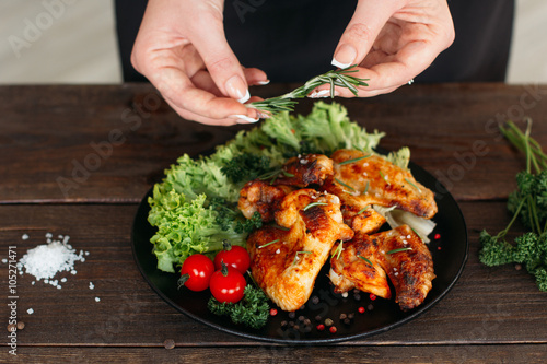 Chief decorated spicy chicken on wooden table