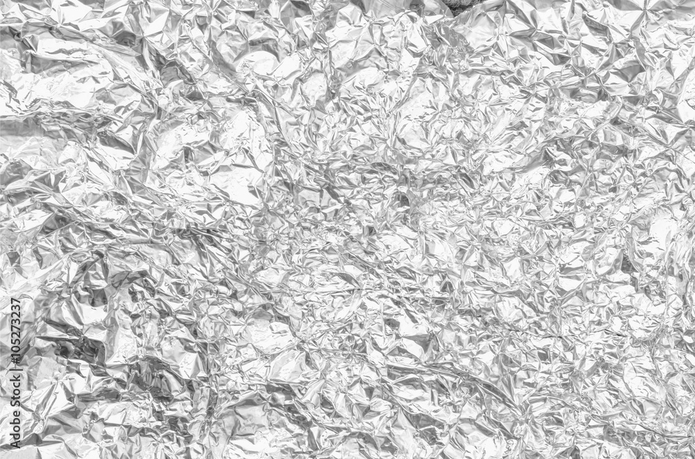 silver leaf foil background with shiny crumpled uneven surface f