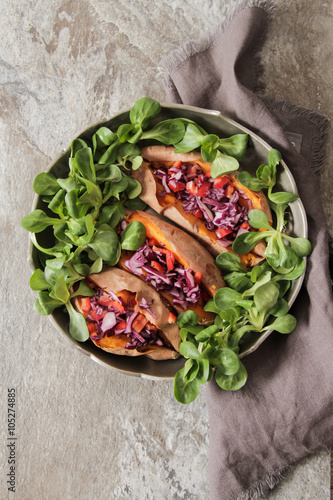 baked sweet potatoes in the oven with carrots and cabbage