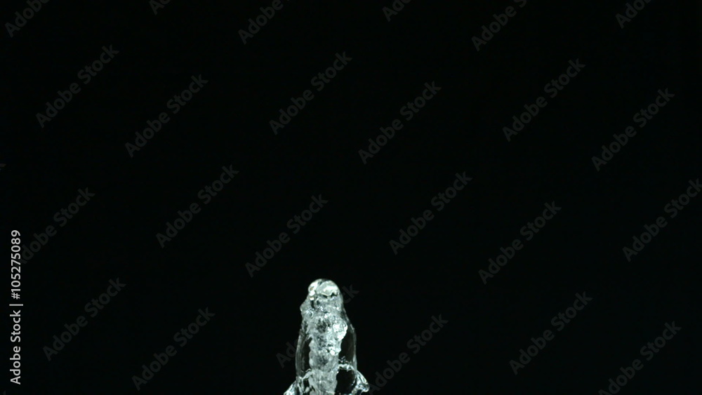 Water spraying on black background, slow motion Water spraying on black background, slow motion