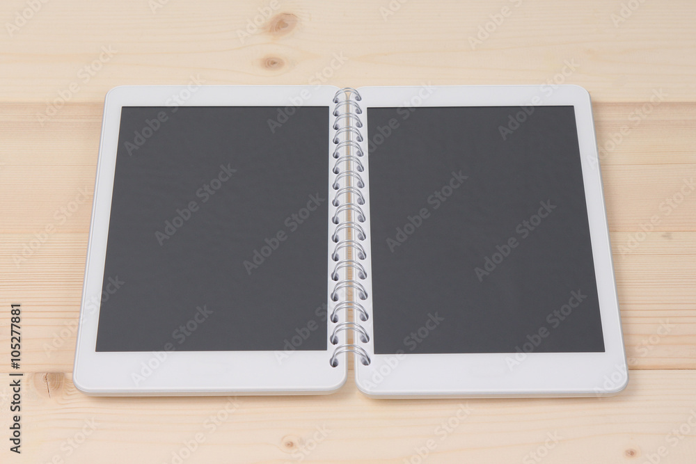 Two digital tablet devices connected with notebook spiral as a concept of opened digital notebook. Two digital tablet devices connected with notebook spiral as a concept of opened digital notebook.