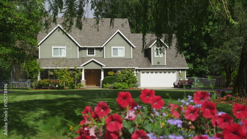 Family home with spring flowers, dolly movement