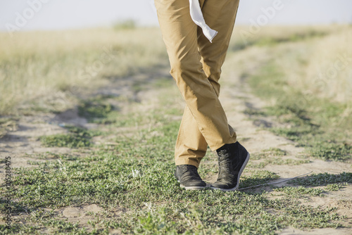 Man standing with brown pants and sneakers