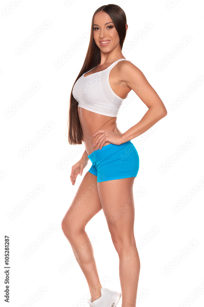 Fitness woman in sport style standing against isolated white background Fitness woman in sport style standing against isolated white background