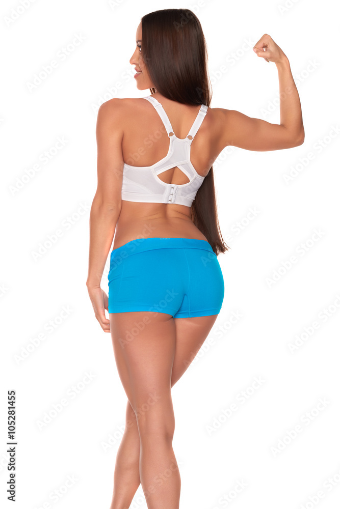 Fitness woman in sport style standing against isolated white background Fitness woman in sport style standing against isolated white background