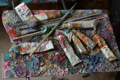 Painting palette with paint tubes and brusher 