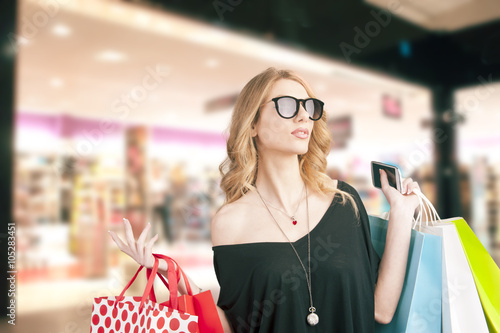 Blonde woman holding shopping bags photo