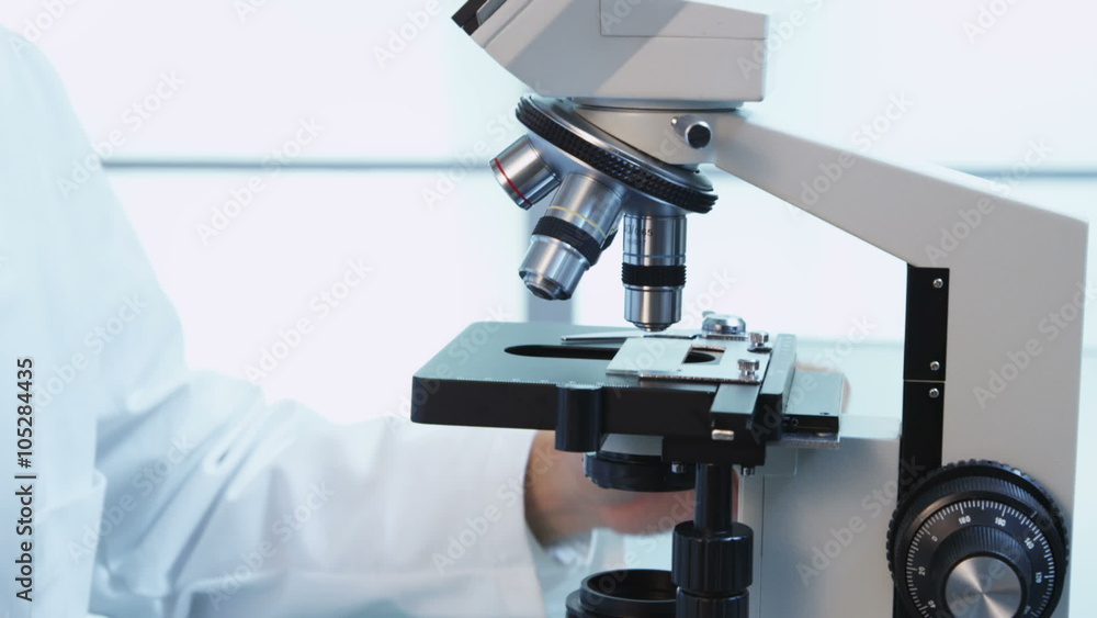 Asian scientist looks into microscope Asian scientist looks into microscope