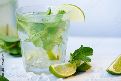 Cold fresh lemonade drink on a wooden background