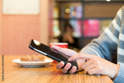Woman touch on cellphone in cafe