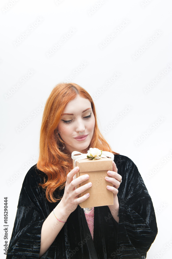 Young redhead woman  with gift box