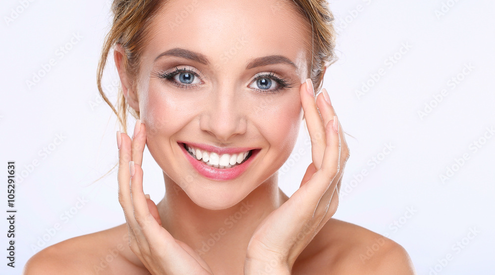 Young woman touching her face isolated on white background Young woman touching her face isolated on white background