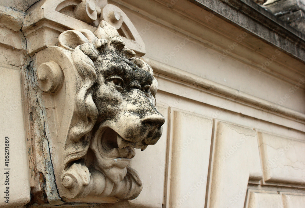 Old stone lion head fence detail
