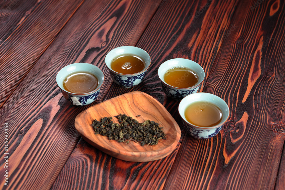 Mug of green tea on wooden background. Imitation Cat's footprints.
