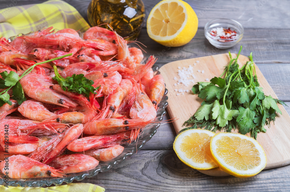 On a dark wooden table dish with shrimps raw On a dark wooden table dish with shrimps raw