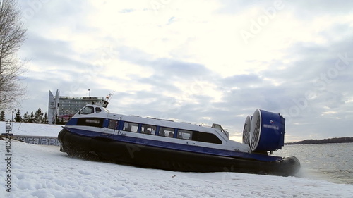 Passenger hovercraft departs from the shore on the river Volga in Russia in the winter
 photo