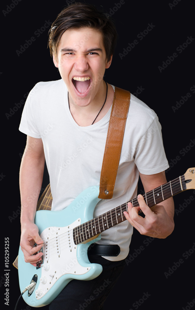 Teenage boy playing electric guitar and singing Stock-Foto | Adobe Stock