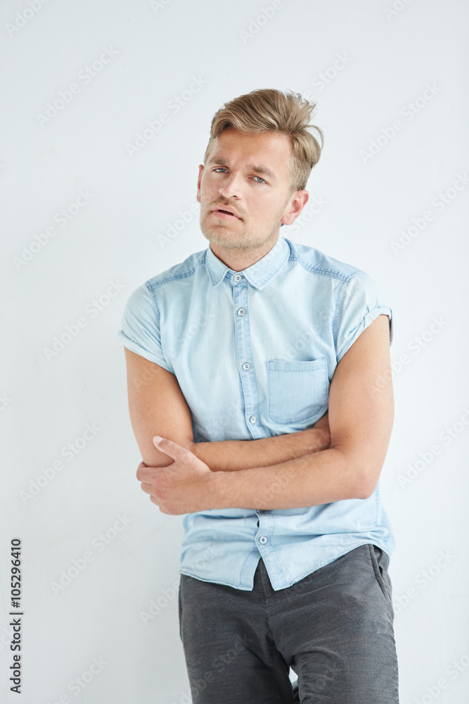 Brutal man in a shirt with short sleeves sitting in the chair , Brutal man in a shirt with short sleeves sitting in the chair ,
