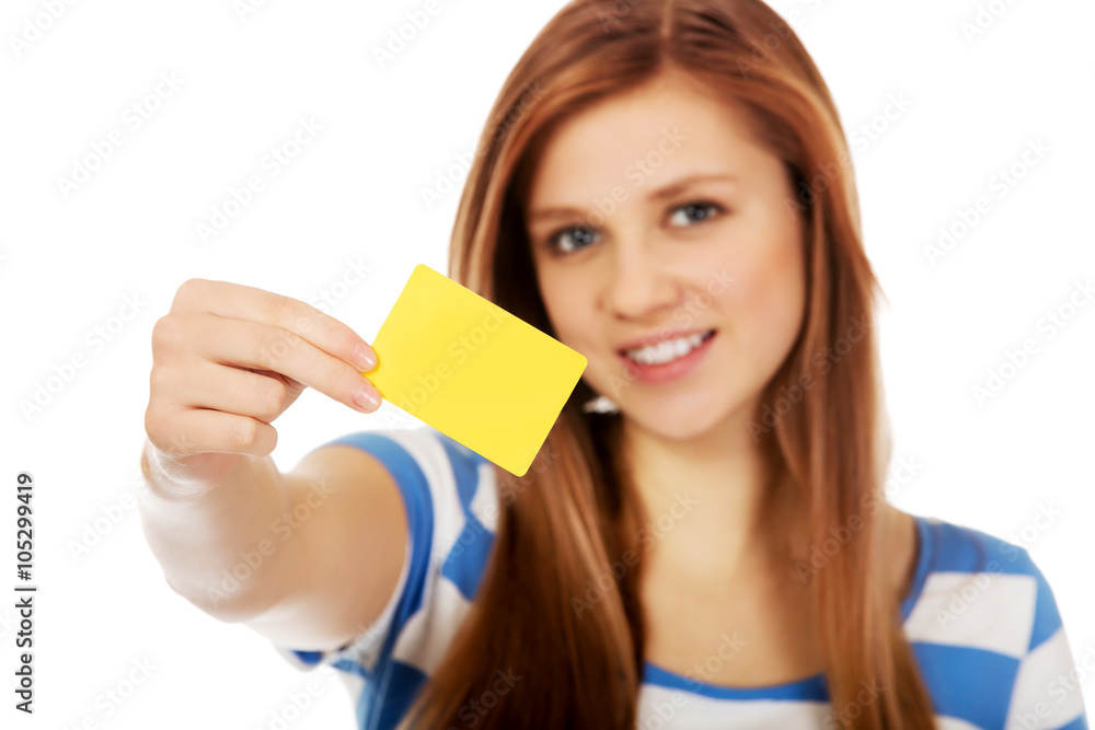 Teenage woman holding empty business card Teenage woman holding empty business card
