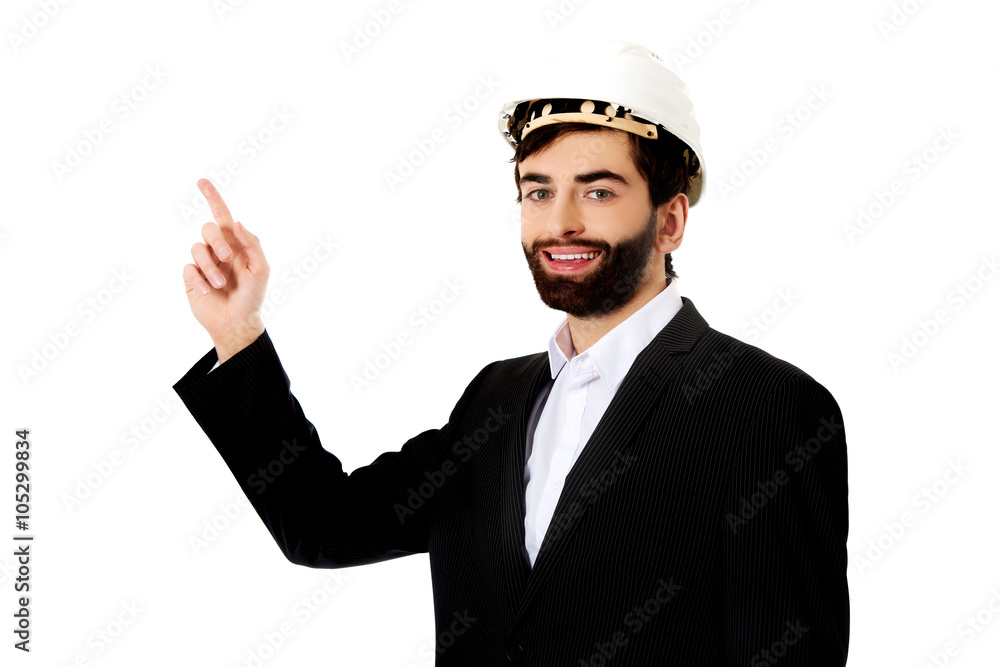 Engineer in protective helmet pointing up. Engineer in protective helmet pointing up.
