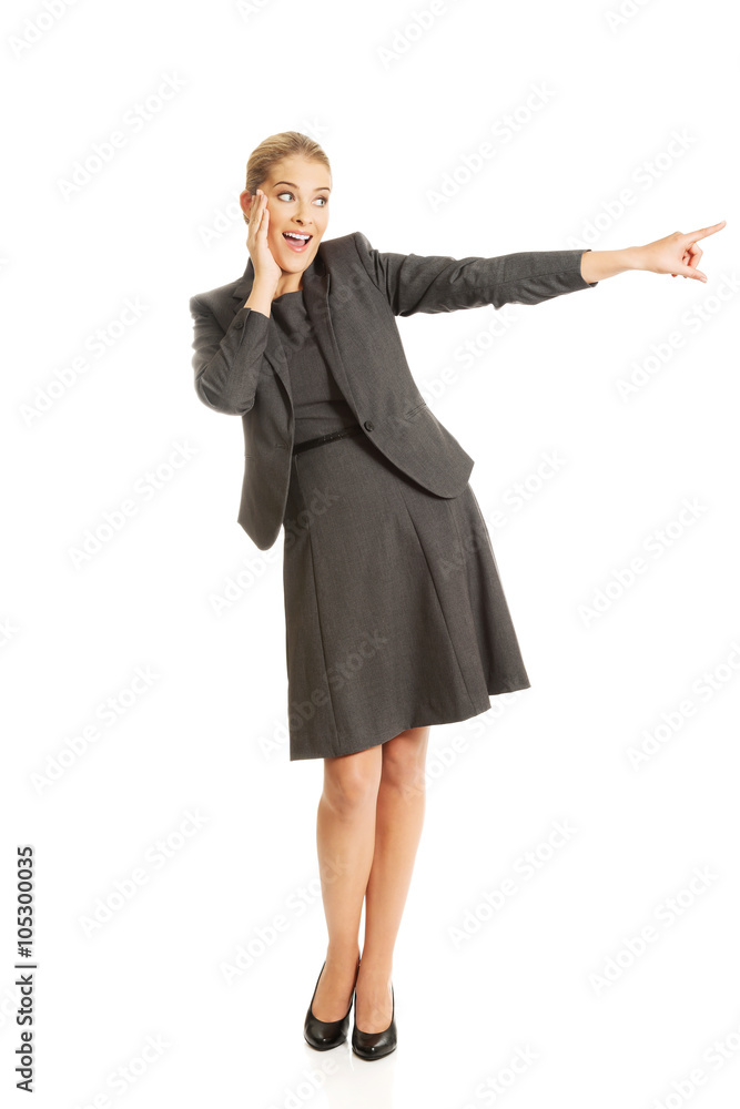 Amazed businesswoman pointing to the right Amazed businesswoman pointing to the right