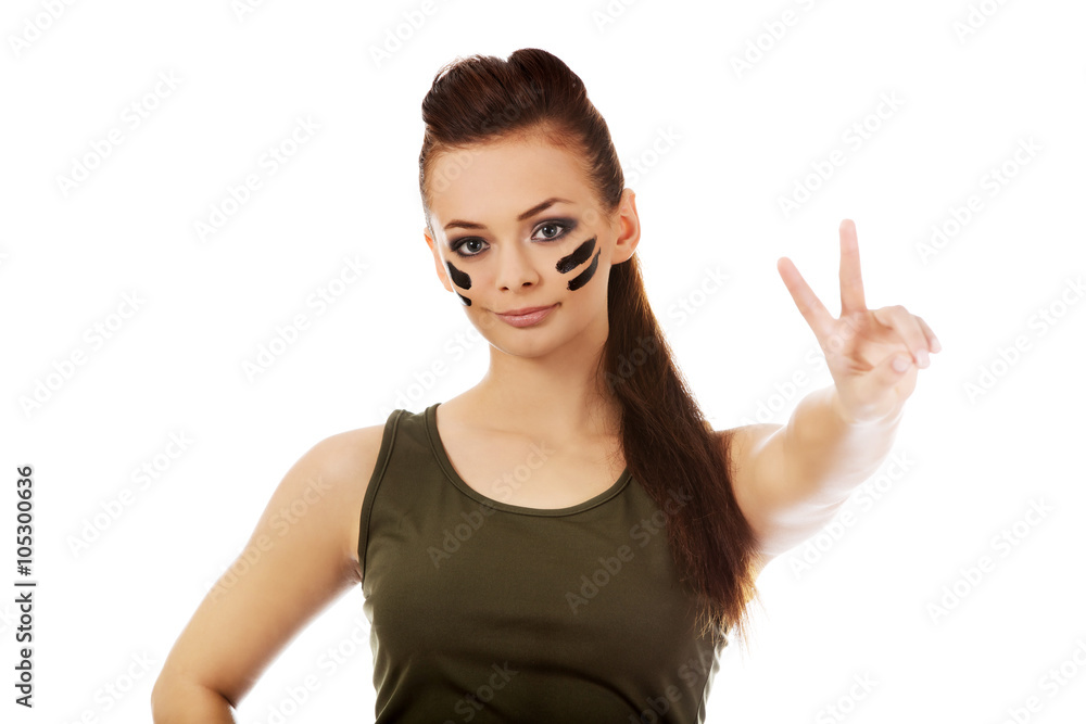 Military woman gesturing peace with fingers Military woman gesturing peace with fingers