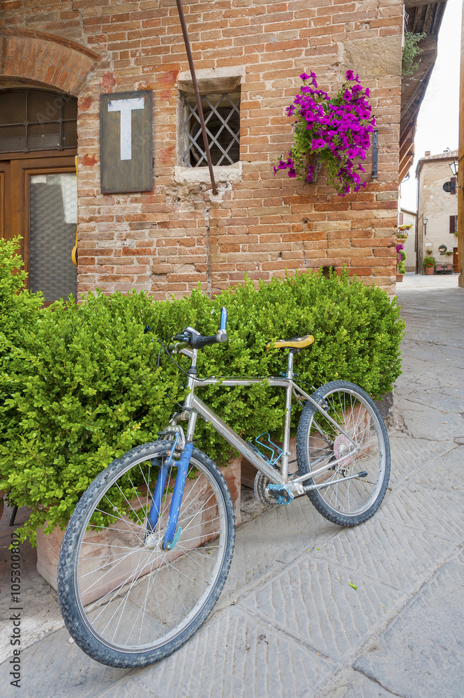 Bicycle in charming street in old town Pienza of Tuscany, Italy,