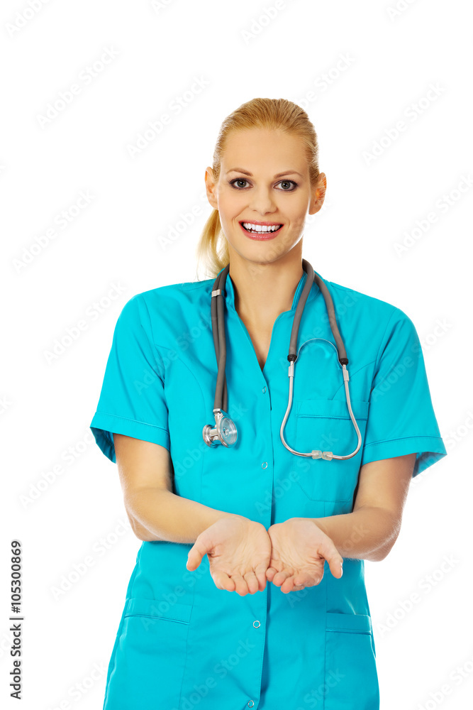 Female doctor or nurse holding something on open palms Female doctor or nurse holding something on open palms