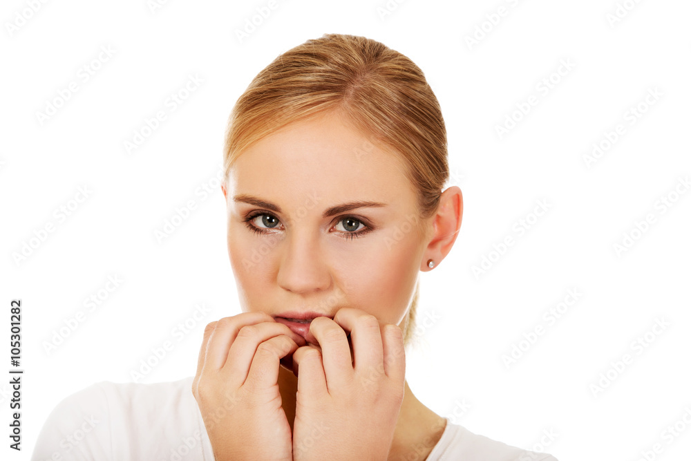 Stressed young woman biting nails Stressed young woman biting nails